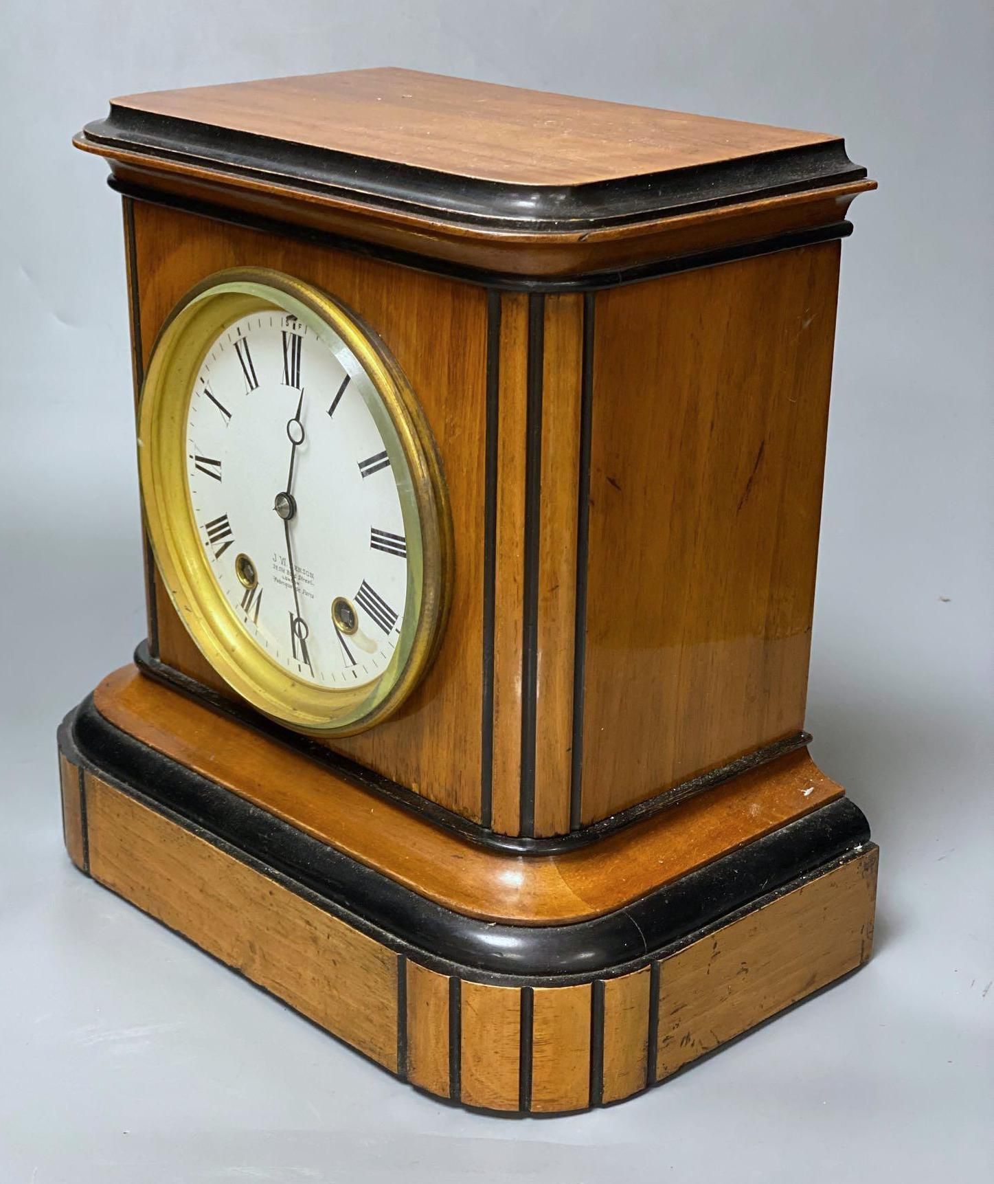 A walnut cased and ebonised mantel clock retailed by JW Benson, French movement striking on a gong, height 27cm